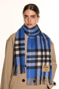 Model styling a pure cashmere scarf with an elegant evening outfit
