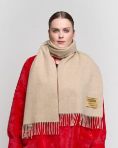 Classic tartan and solid scarves displayed to show heritage craftsmanship
