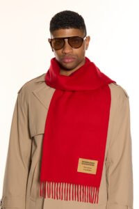 A red tartan cashmere scarf elegantly draped over a chair.