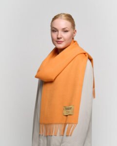 People of different cultures sharing gifts and wearing iconic Scottish cashmere scarves.